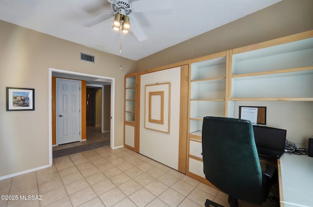 unfurnished office featuring light tile patterned floors and ceiling fan