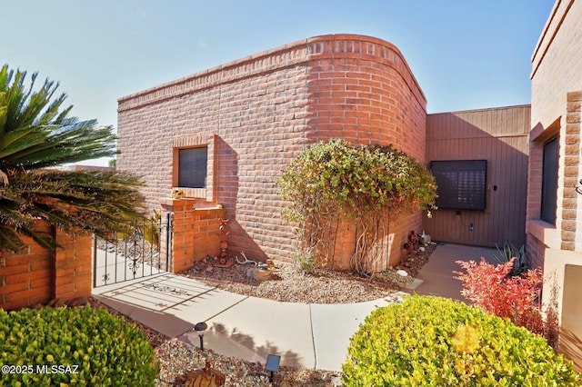 view of side of property with a gate