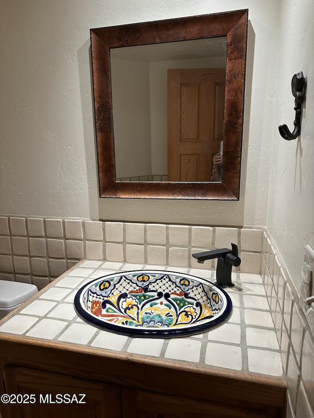 interior details with sink and decorative backsplash