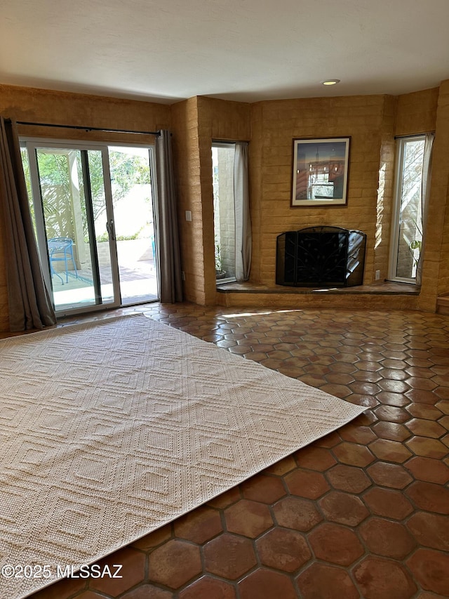 unfurnished bedroom with tile patterned flooring and access to outside