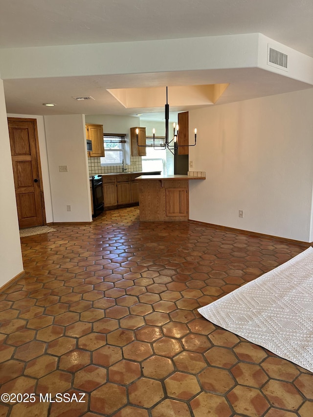 interior space with a notable chandelier and dark tile patterned flooring