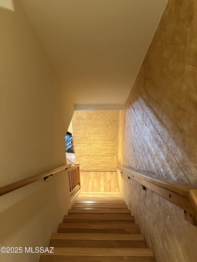 stairs featuring hardwood / wood-style floors