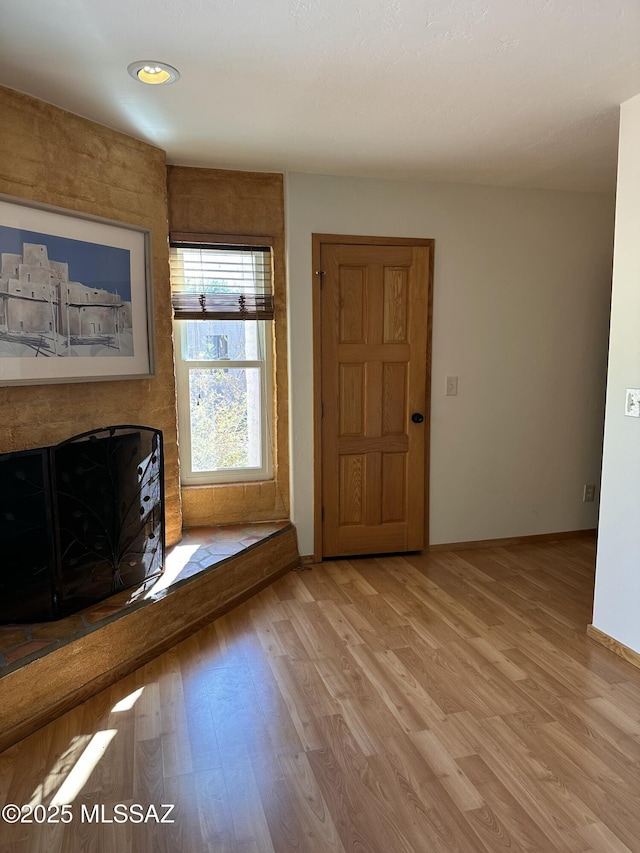 unfurnished living room featuring light wood-type flooring