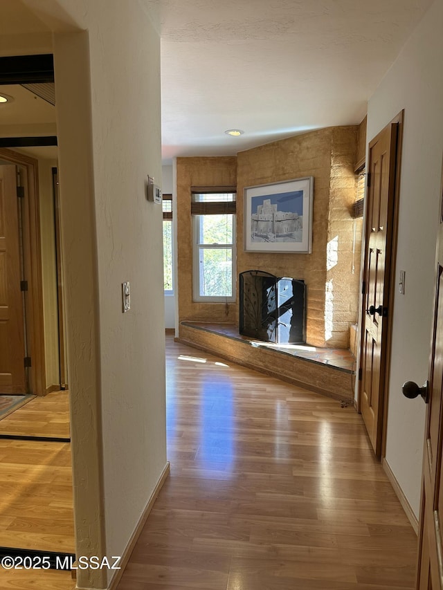 corridor with hardwood / wood-style floors