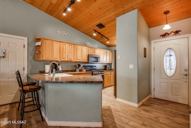 kitchen with light brown cabinets, stainless steel appliances, a peninsula, a sink, and wood ceiling