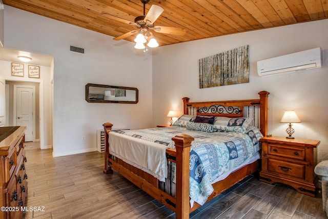 bedroom featuring wooden ceiling, wood finish floors, visible vents, baseboards, and a wall mounted AC