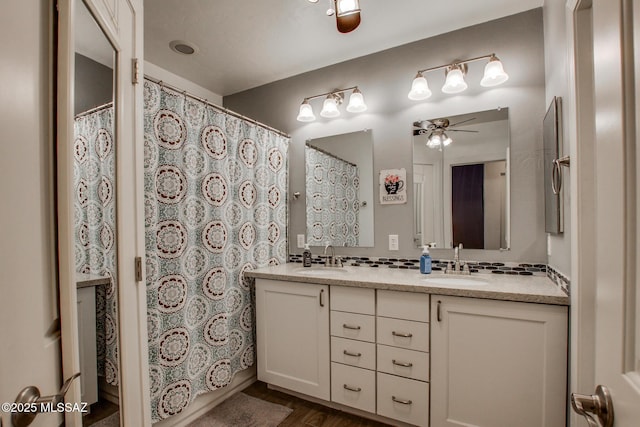 full bathroom with double vanity, ceiling fan, decorative backsplash, and a sink