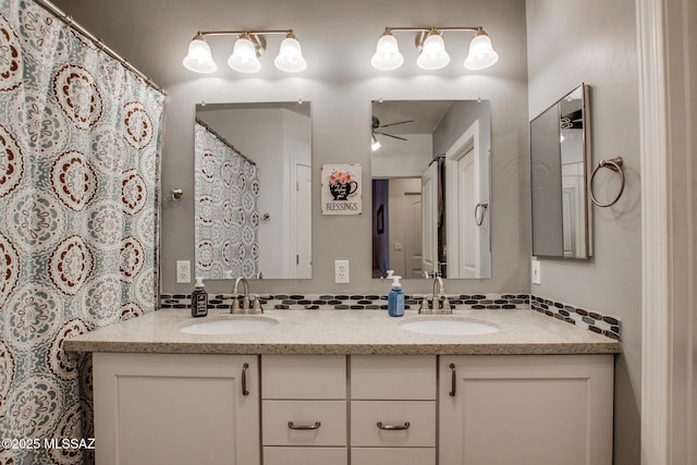 bathroom featuring double vanity, a ceiling fan, and a sink