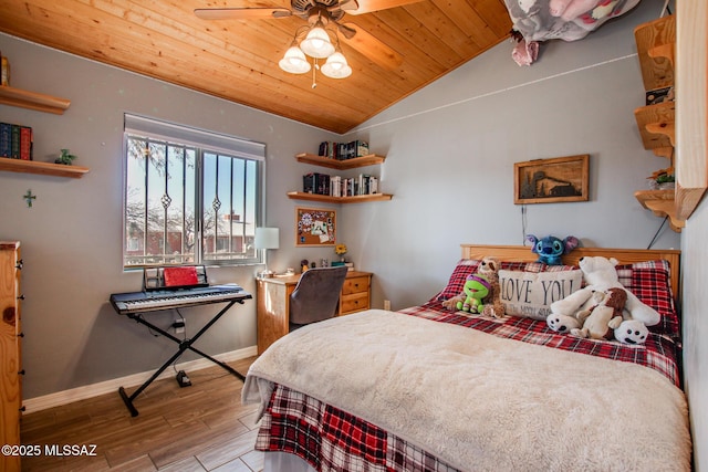 bedroom with lofted ceiling, wooden ceiling, baseboards, and wood finished floors