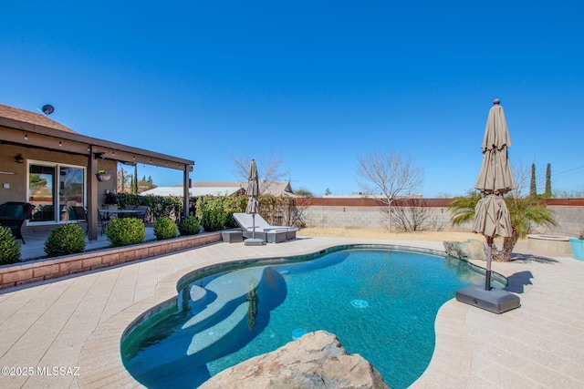 view of pool featuring a patio area, a fenced backyard, and a fenced in pool