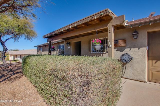 exterior space with a garage and stucco siding