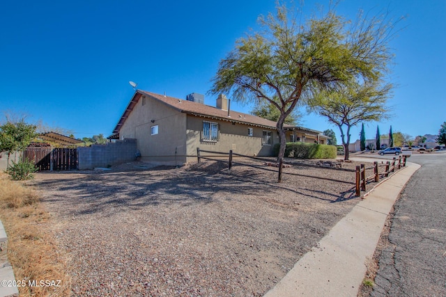 view of front of home featuring fence and a chimney