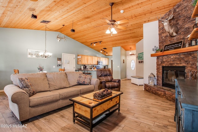 living room featuring visible vents, wood ceiling, light wood-style flooring, a fireplace, and high vaulted ceiling