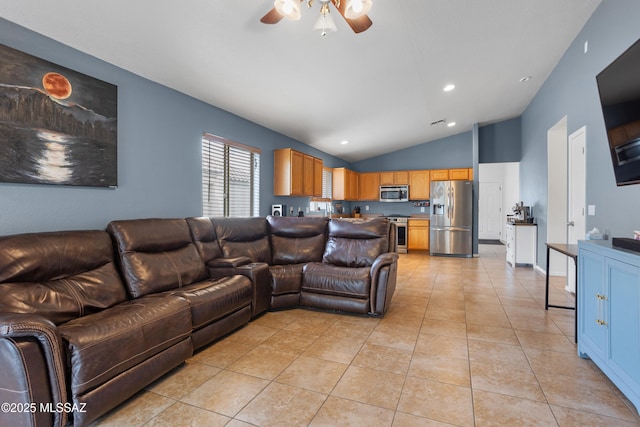 living room with vaulted ceiling, ceiling fan, and light tile patterned flooring