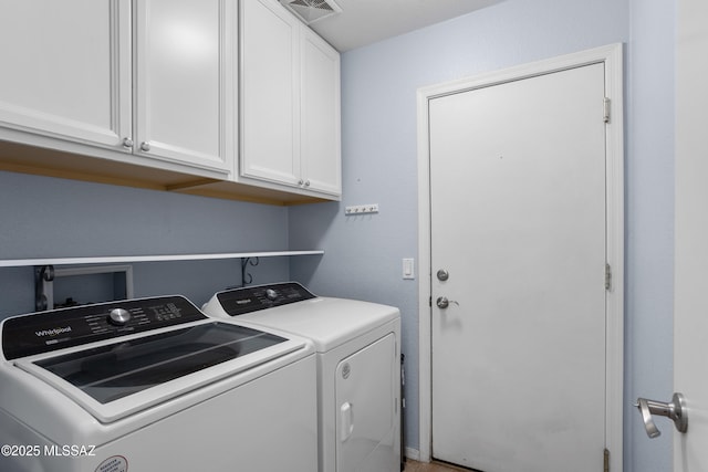 laundry area with cabinets and washer and clothes dryer