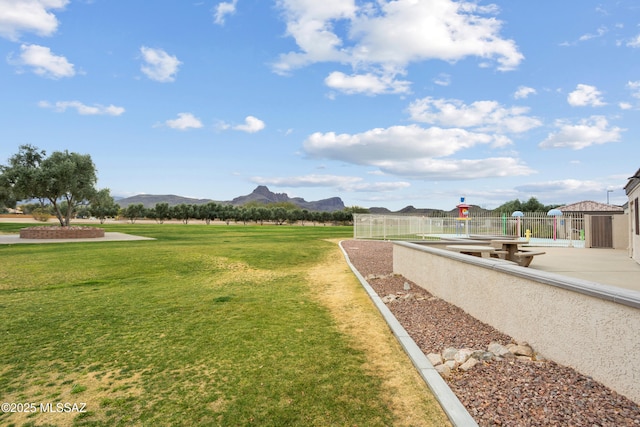 surrounding community featuring a mountain view and a yard