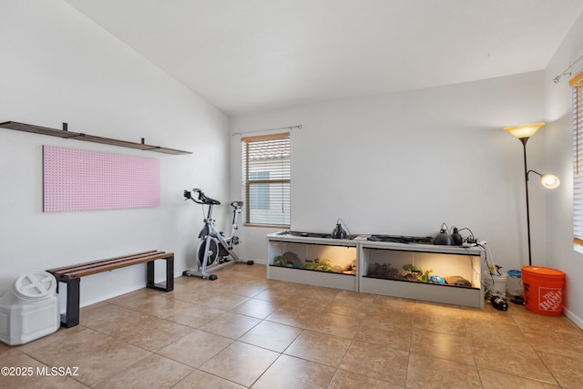 misc room featuring light tile patterned flooring and lofted ceiling