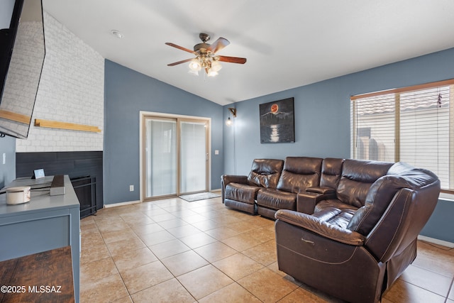 living room featuring light tile patterned flooring, ceiling fan, and vaulted ceiling