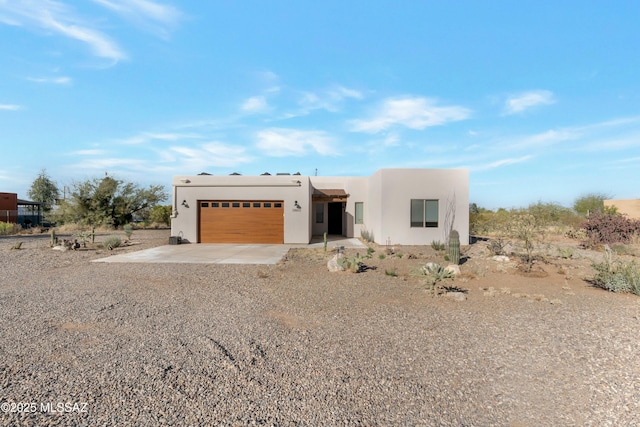 pueblo-style home with a garage