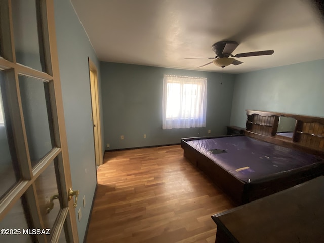 unfurnished bedroom featuring hardwood / wood-style flooring and ceiling fan