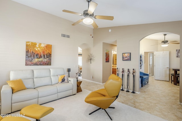 36425 S Golf Course Dr, Tucson, AZ 85739 - living room with visible vents, high vaulted ceiling, a ceiling fan, arched walkways, and baseboards