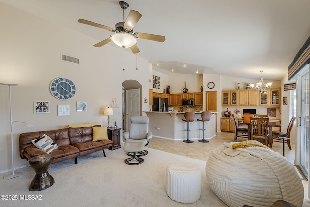 36425 S Golf Course Dr, Tucson, AZ 85739 - living room featuring visible vents, high vaulted ceiling, light tile patterned flooring, arched walkways, and ceiling fan with notable chandelier