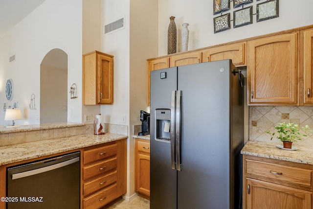 36425 S Golf Course Dr, Tucson, AZ 85739 - kitchen with light stone counters, visible vents, backsplash, and appliances with stainless steel finishes
