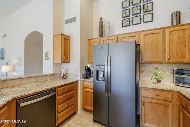 36425 S Golf Course Dr, Tucson, AZ 85739 - kitchen featuring light stone counters, light tile patterned floors, visible vents, stainless steel appliances, and tasteful backsplash