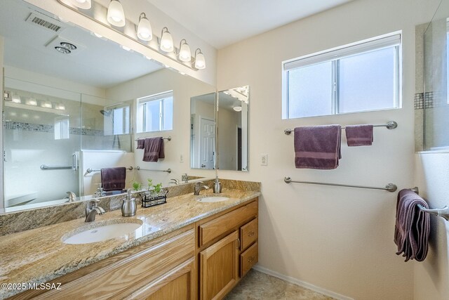 36425 S Golf Course Dr, Tucson, AZ 85739 - bathroom featuring double vanity, tiled shower, visible vents, and a sink