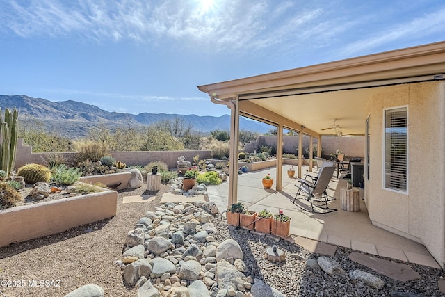 36425 S Golf Course Dr, Tucson, AZ 85739 - view of patio featuring a mountain view, a vegetable garden, a fenced backyard, and a ceiling fan