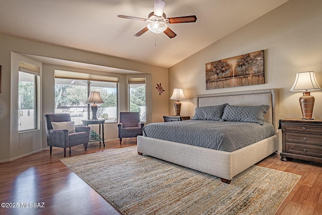 bedroom featuring hardwood / wood-style flooring, vaulted ceiling, and ceiling fan