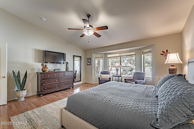 bedroom with light hardwood / wood-style flooring, ceiling fan, and vaulted ceiling