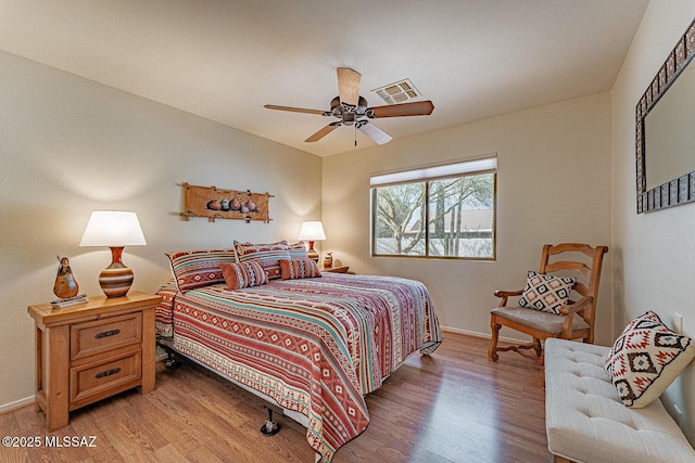 bedroom with light hardwood / wood-style floors and ceiling fan