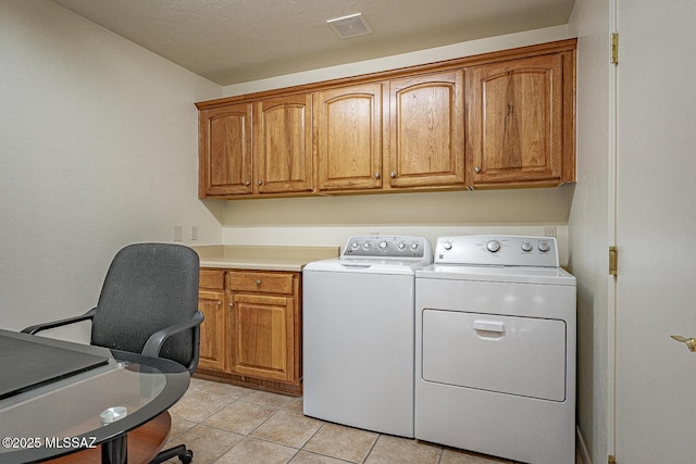 laundry room with cabinets, separate washer and dryer, and light tile patterned floors