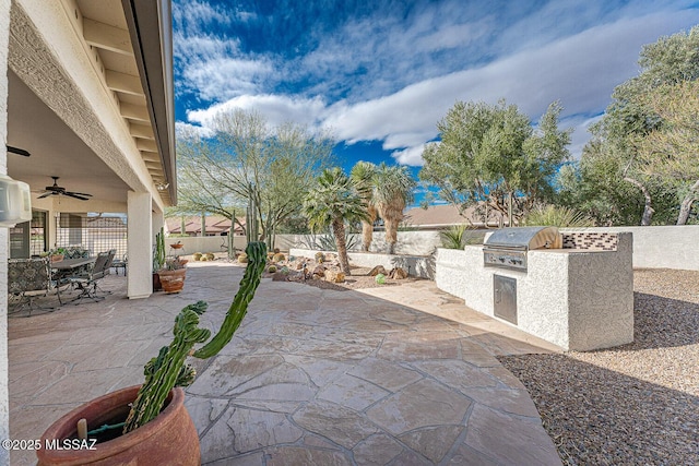 view of patio with ceiling fan, a grill, and exterior kitchen