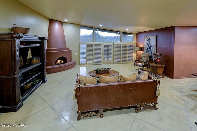 tiled living room with floor to ceiling windows and recessed lighting