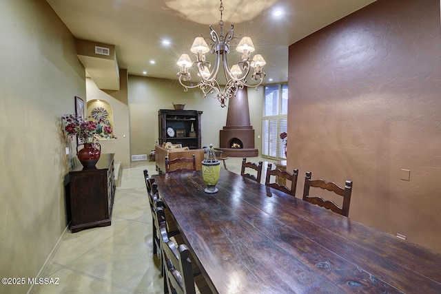 dining area featuring a textured wall, recessed lighting, visible vents, baseboards, and a wood stove