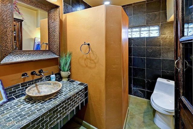 bathroom featuring tile patterned flooring and toilet