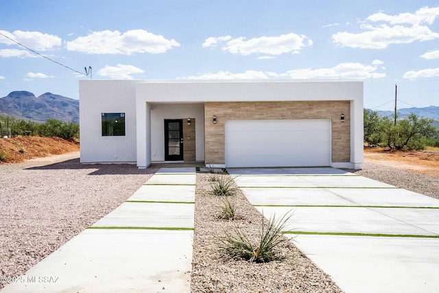 view of front facade with a garage and a mountain view