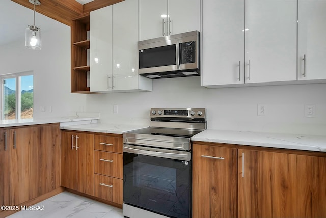 kitchen featuring white cabinetry, appliances with stainless steel finishes, and light stone counters