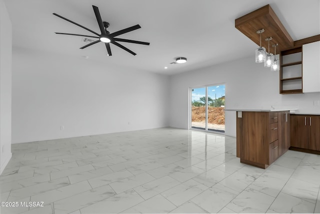 kitchen featuring decorative light fixtures, kitchen peninsula, and ceiling fan