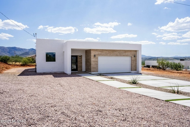 view of front of house with a garage and a mountain view