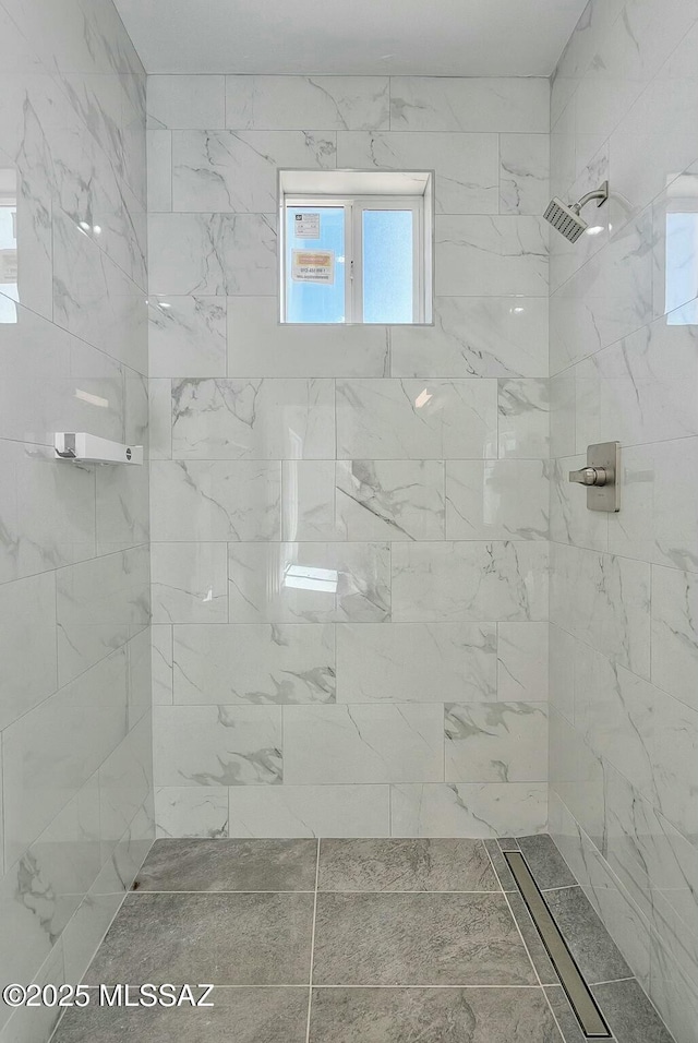 bathroom with tiled shower