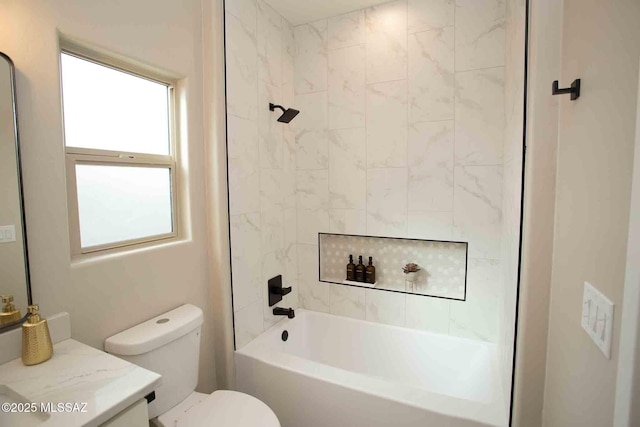 full bathroom with vanity, tiled shower / bath, and toilet