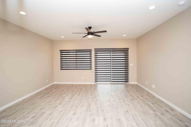 spare room with ceiling fan and light wood-type flooring