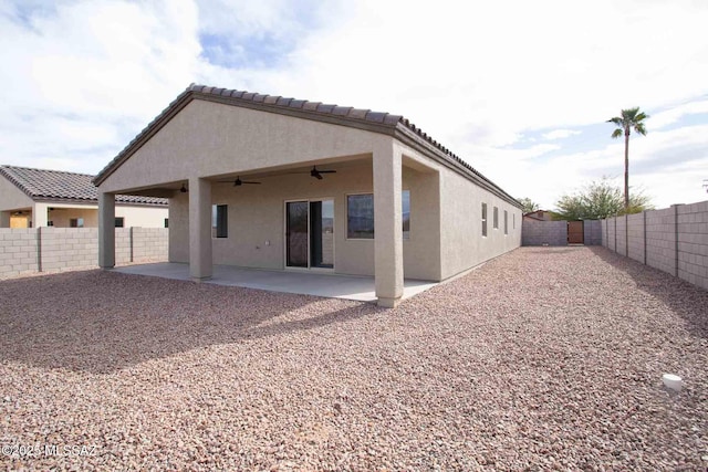 rear view of property featuring a patio area and ceiling fan