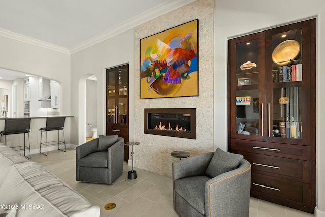 tiled living room featuring ornamental molding