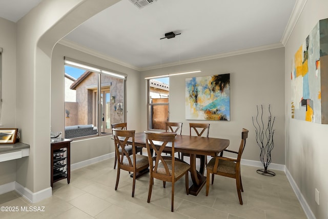 dining space featuring crown molding and light tile patterned floors