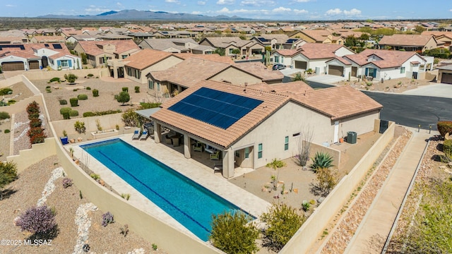 view of swimming pool with a mountain view and a patio area