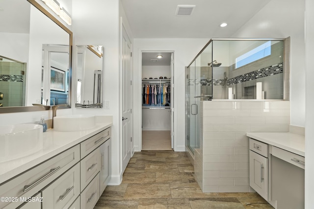 bathroom with vanity and a shower with shower door